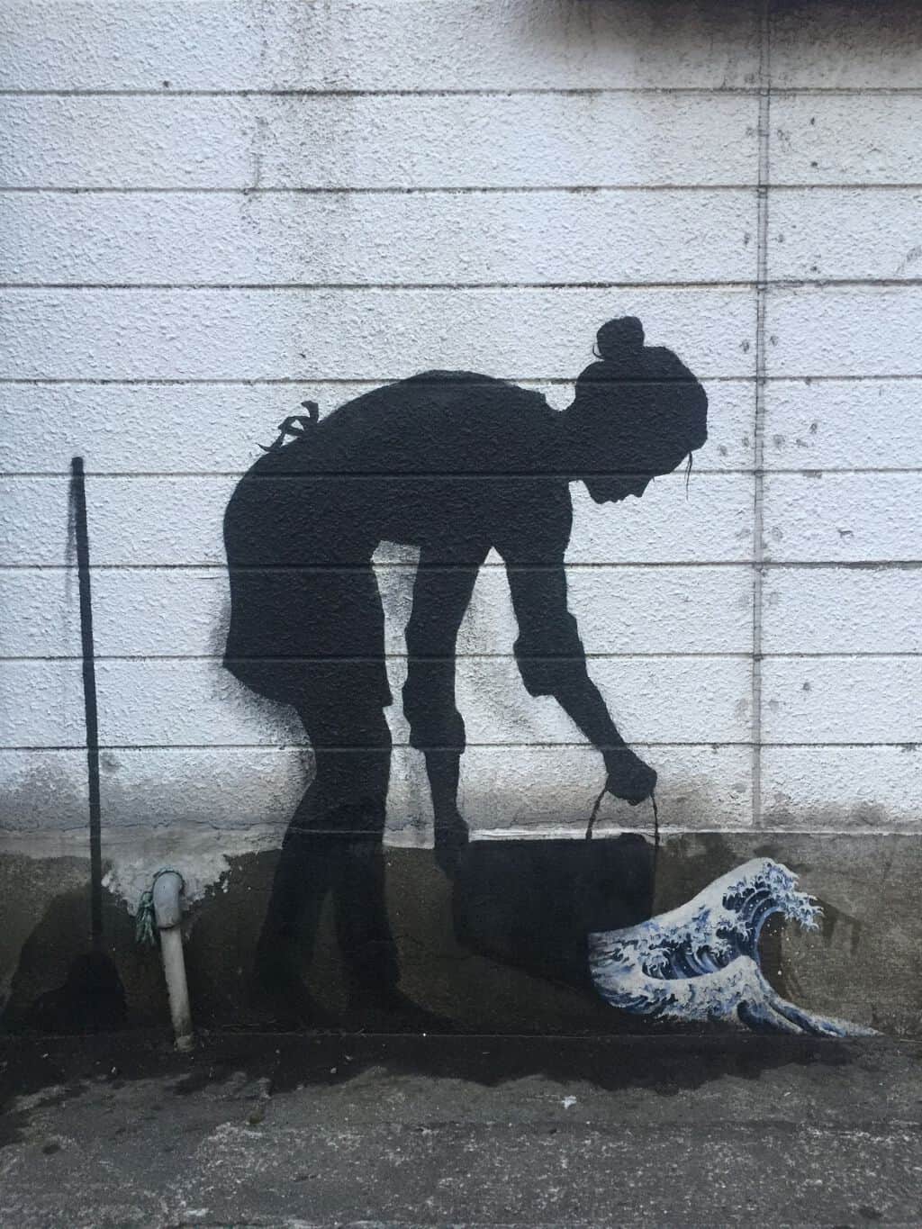 "Laborer Digging with Wave" by Pejac in Tokyo