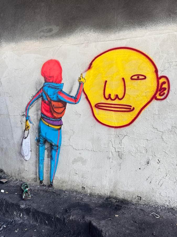 "Figure High-Fiving Emotional Face" by Os Gêmeos in Sao Paulo