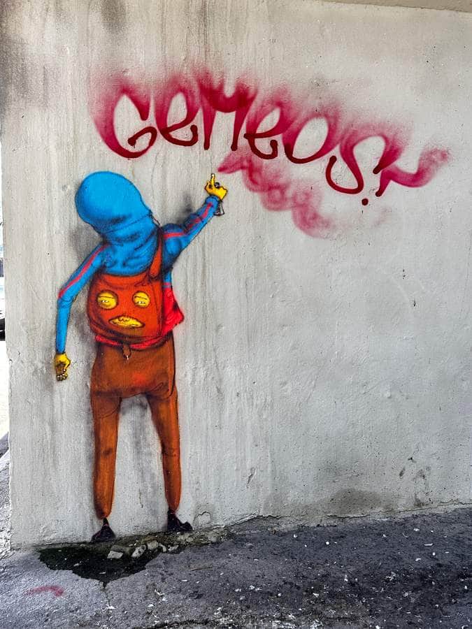 "Blue Figure Spray Painting Graffiti" by Os Gêmeos in Sao Paulo