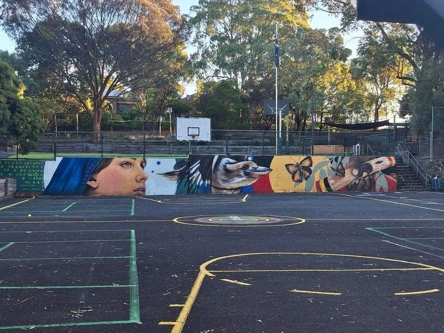 "Colorful Portrait Mural on Court" by Paink in Melbourne