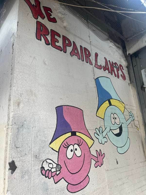 "We Repair Lamps Cartoon Characters" by Michael Galinsky in New York
