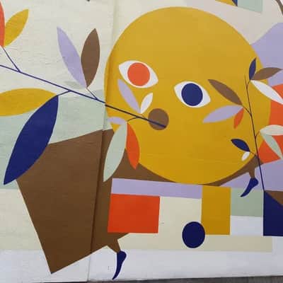"Whimsical Yellow Face with Foliage" by HELL'O in Saint Josse Ten Noode