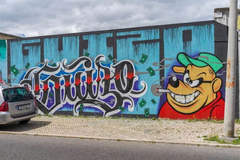 "Money-Loving Character with Graffiti Text" by Guizo in Lisbon