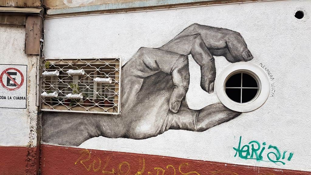 "Mano tomando ventana" by Alexandra Wuzyk in Valparaiso