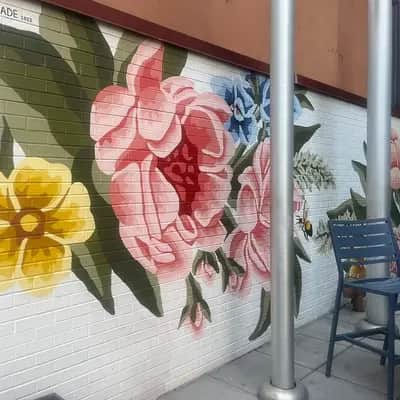 "Vibrant Floral Brick Wall Mural" by Alixandra Jade in New York