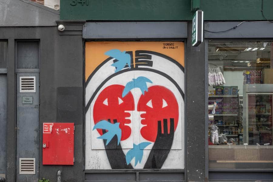 "Dual Faces with Blue Hands" by Yorgos in London