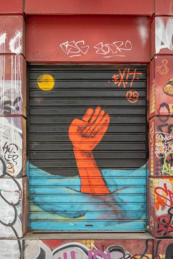 "Raised Fist Rising from Water" by exit in Athens