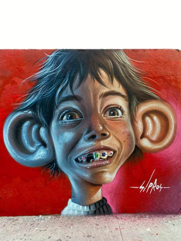 "Exaggerated Child Portrait with Braces" by Sipros in Sao Paulo