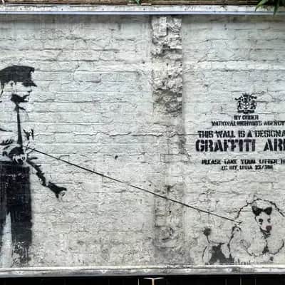"Graffiti Area / Guard Dog" by Banksy in London