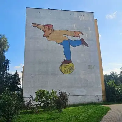 Footballer Balancing on Medal
