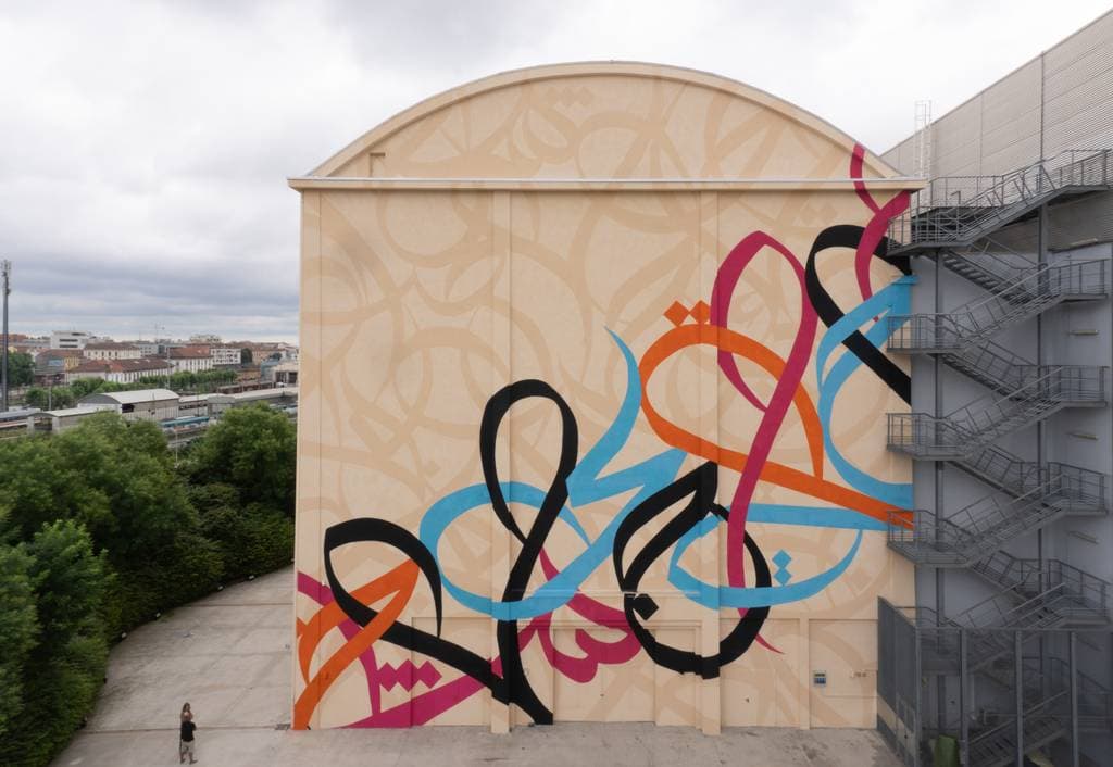 "Waves only exist because the wind blows" by El Seed in Municipio 9, Milan