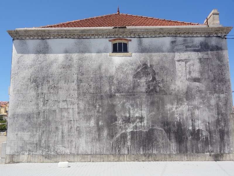 Faded Portrait on Historic Facade