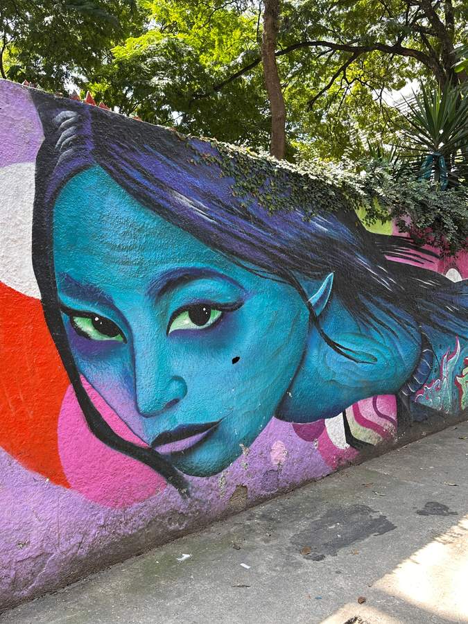 Blue-Faced Figure with Striking Eyes