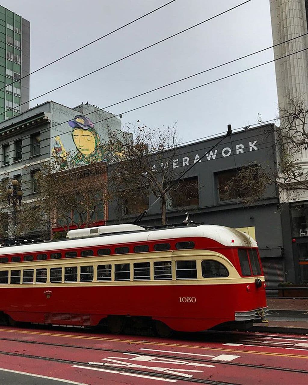 "Yellow Face with Purple Hat" by Os Gemeos in South Of Market, San Francisco
