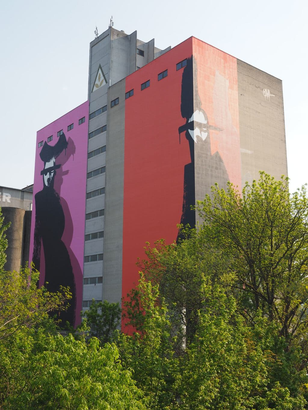 Silhouetted Figures on Urban Facade
