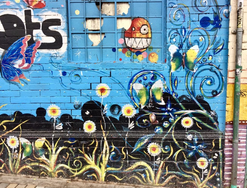"Indígena y fachadas en La Candelaria" by Various Artists in Las Aguas, Bogota