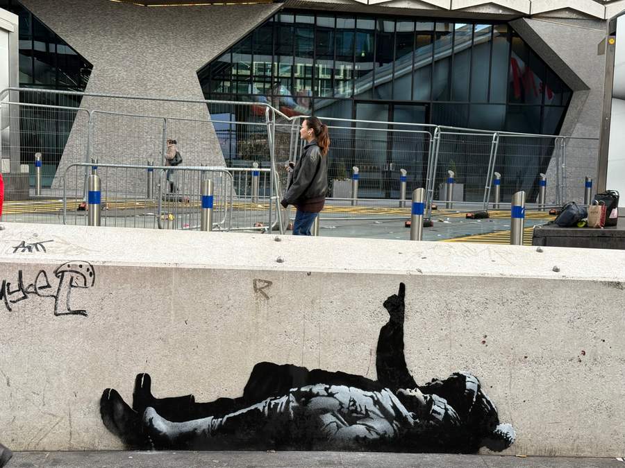 "Fallen Figure Street Mural" by Banksy in St Giles, London