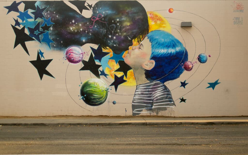 Child Blowing Cosmic Universe