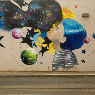 Child Blowing Cosmic Universe