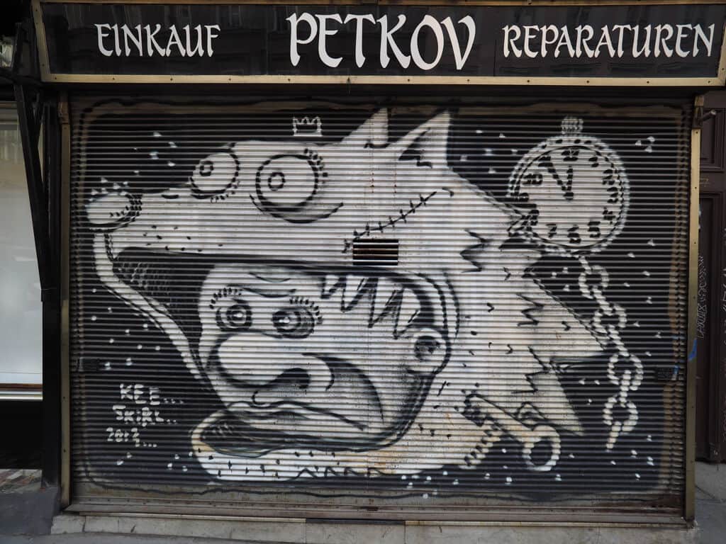 "Lucky Cat Storefront Shutter Art" by Skirl in Vienna