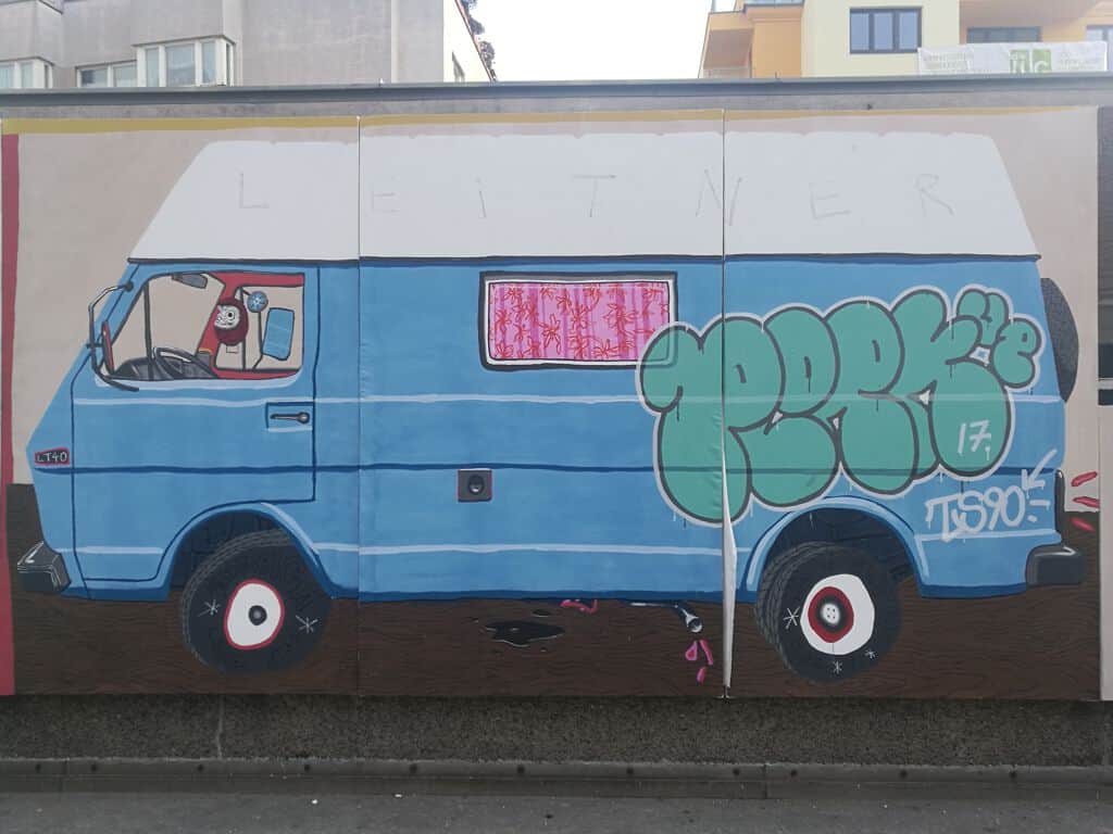 "Blue Camper Van with Graffiti" by David Leitner in Vienna