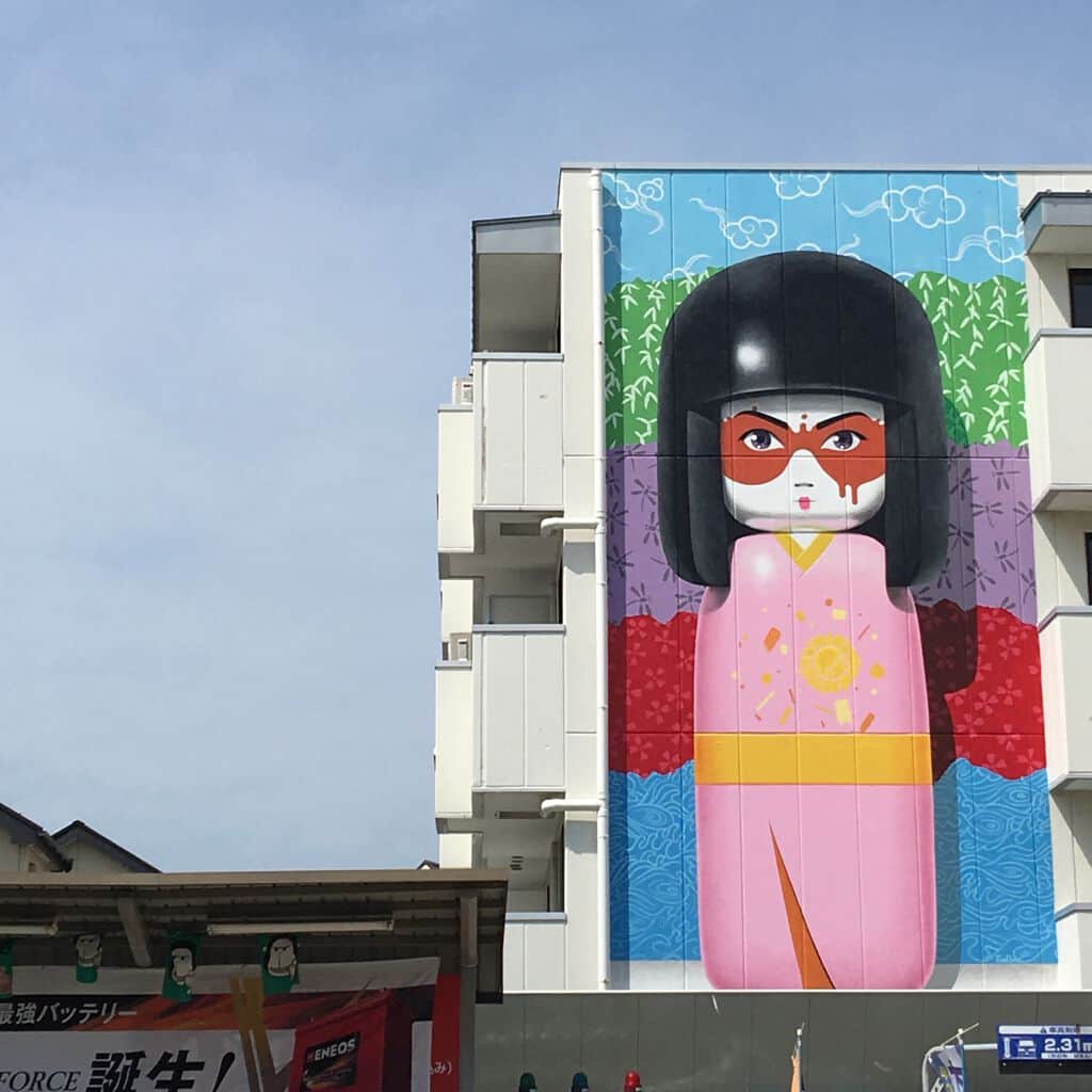 "Colorful Doll Figure with Red Mask" by Fin DAC in Tokyo