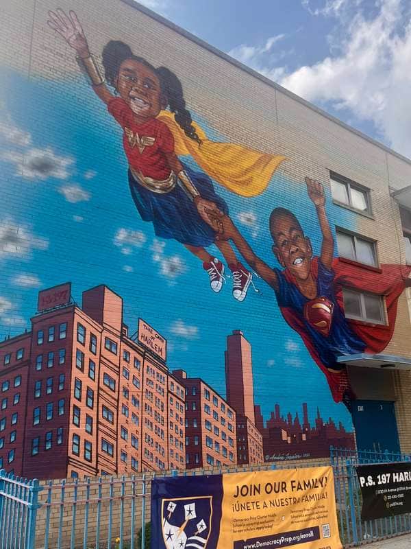 "Superhero Children Flying Over City" by Andre Trenier in New York