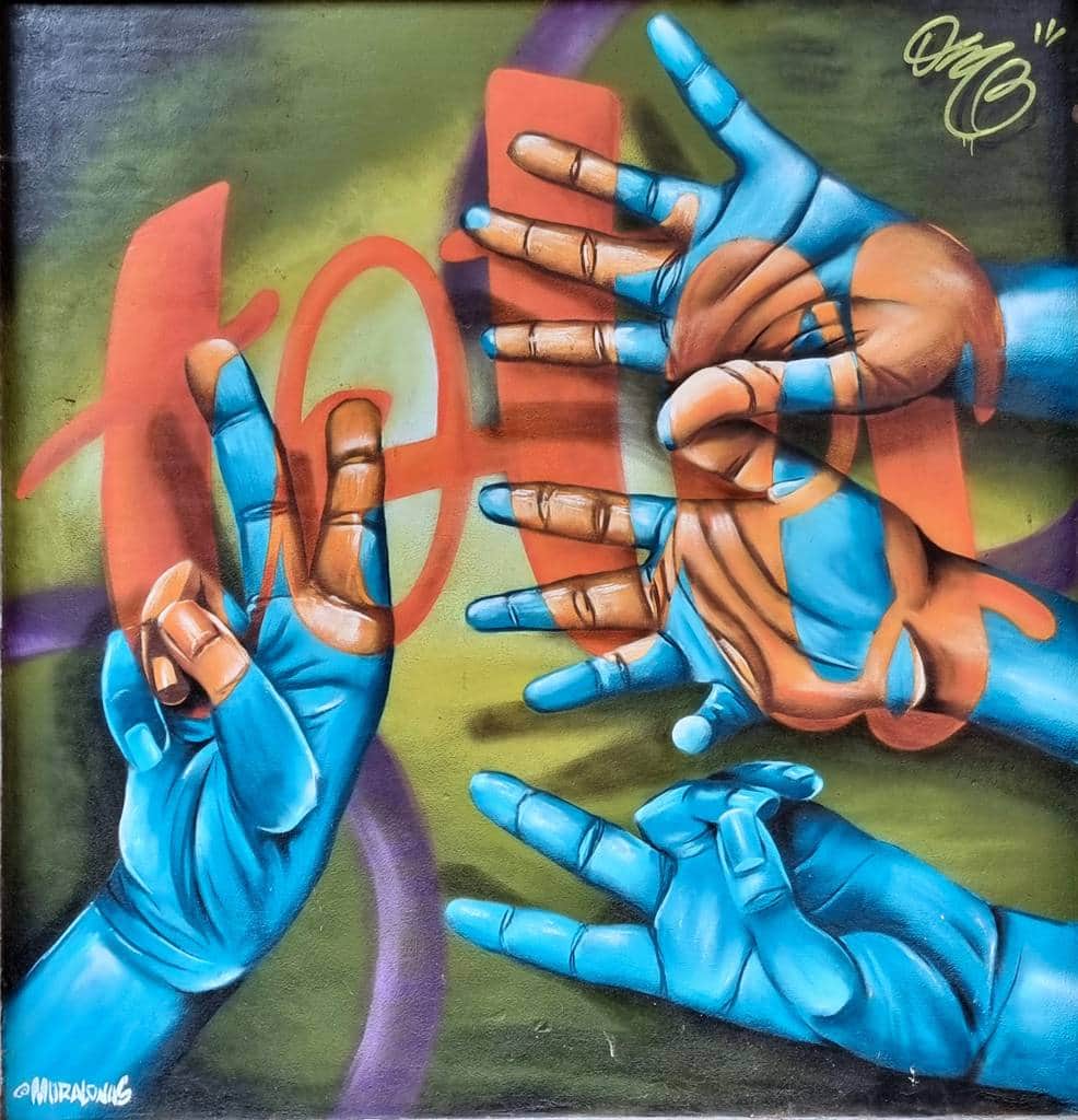 "Hands Holding Ammunition and Numbers" by Muralonas in Barcelona