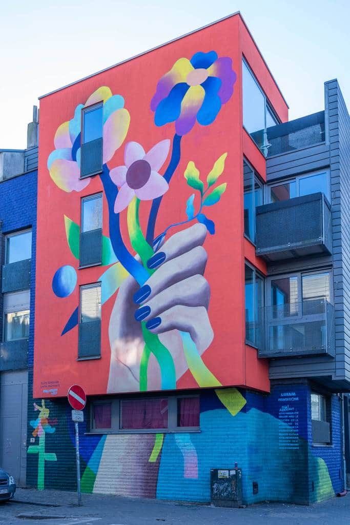 "Colorful Hand Holding Flowers" by Elize Sokolova in Brussels