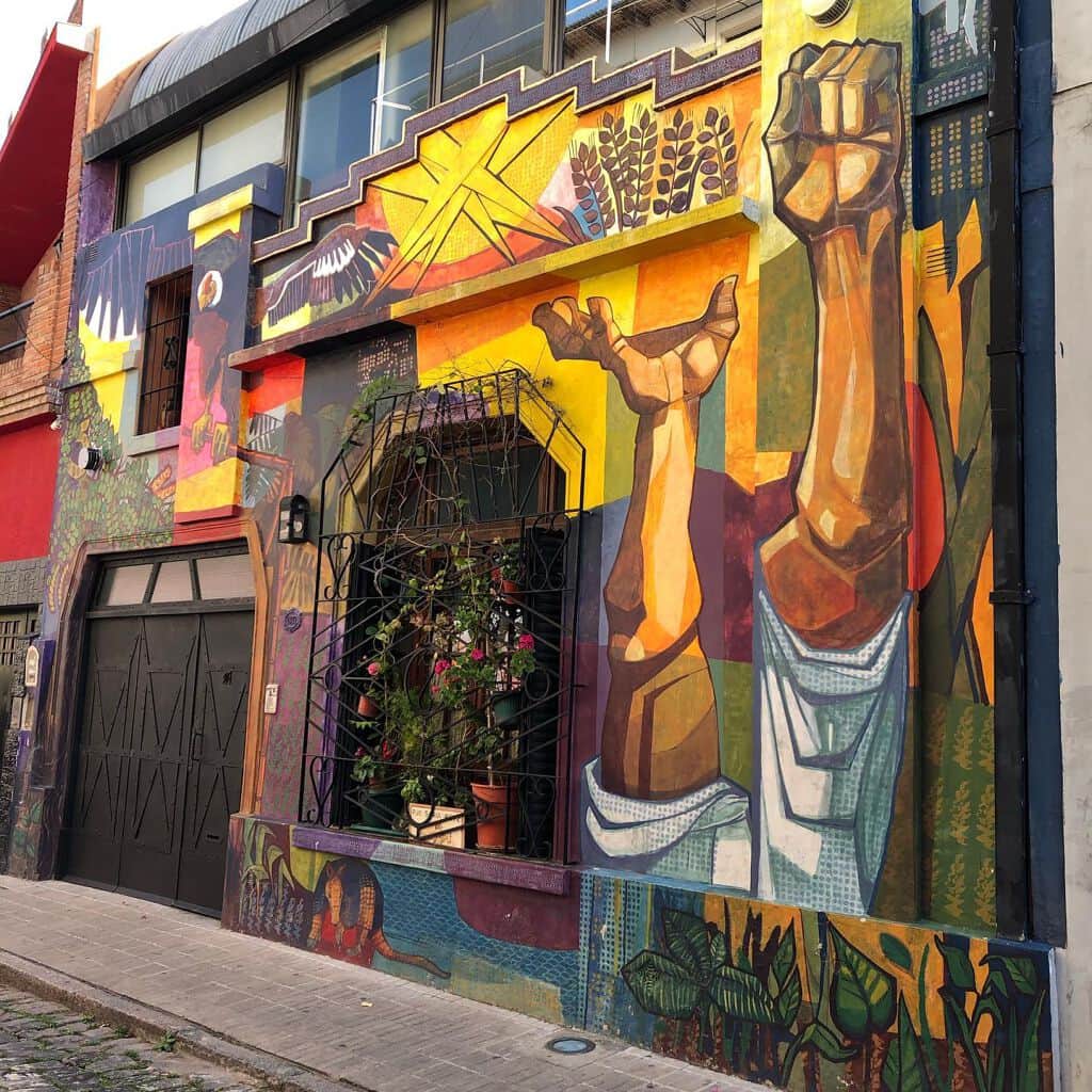 "Vibrant Mural of Laboring Figures" by Muralismo Nómade en Resistencia in Buenosaires