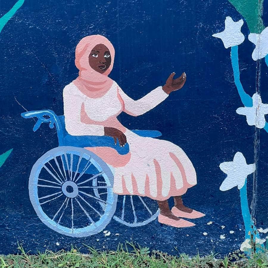 "Woman in Wheelchair with Flowers" by Color Squad Collective in Austin